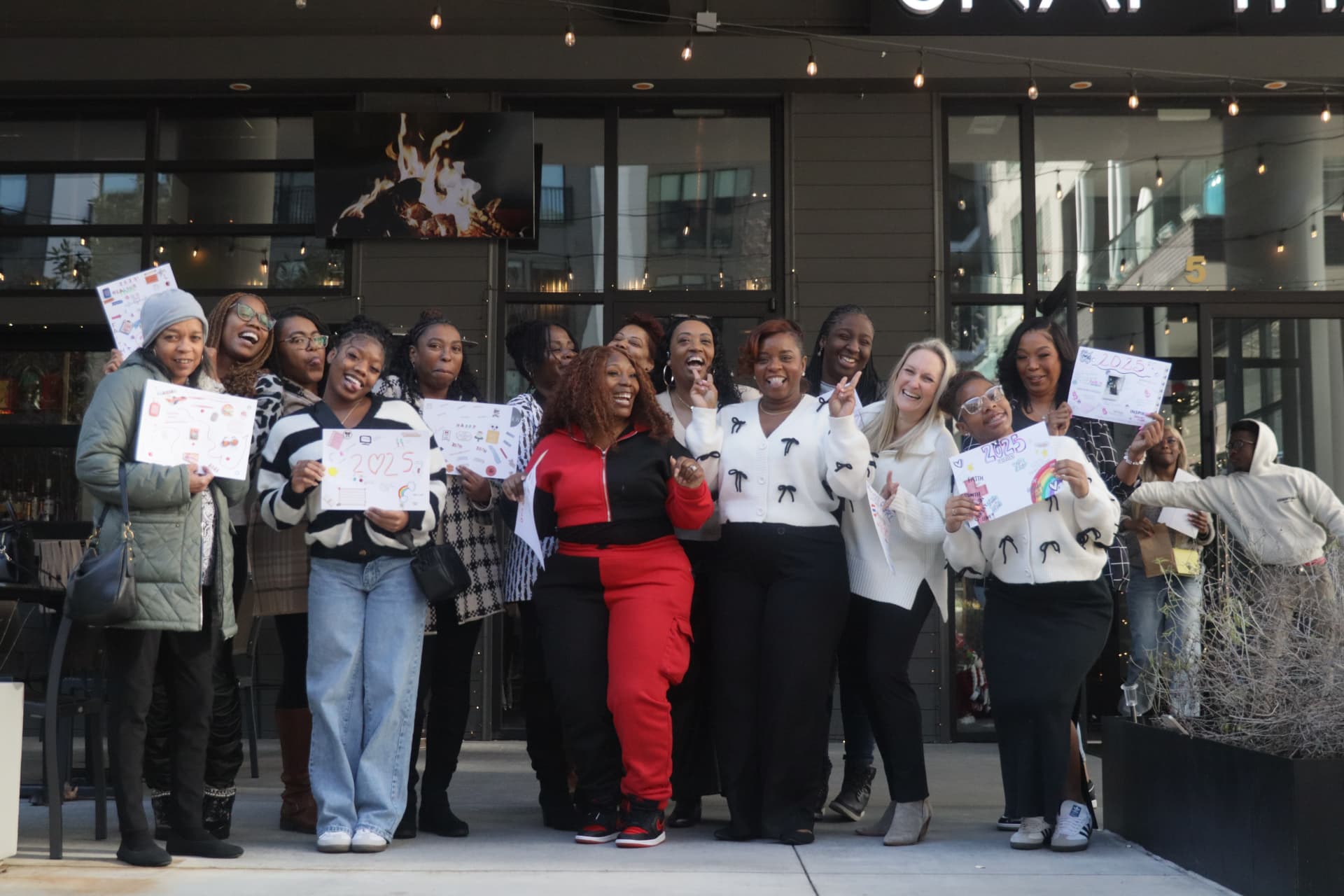 The first Rest House cohort of 20 women holding their vision boards at the In Vision Brunch, January 2025